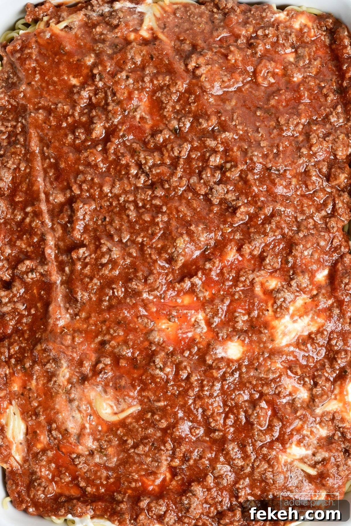 Cheesy Baked Spaghetti Casserole Recipe for Weeknight Dinners 11 Meat sauce layer added to million dollar spaghetti casserole.