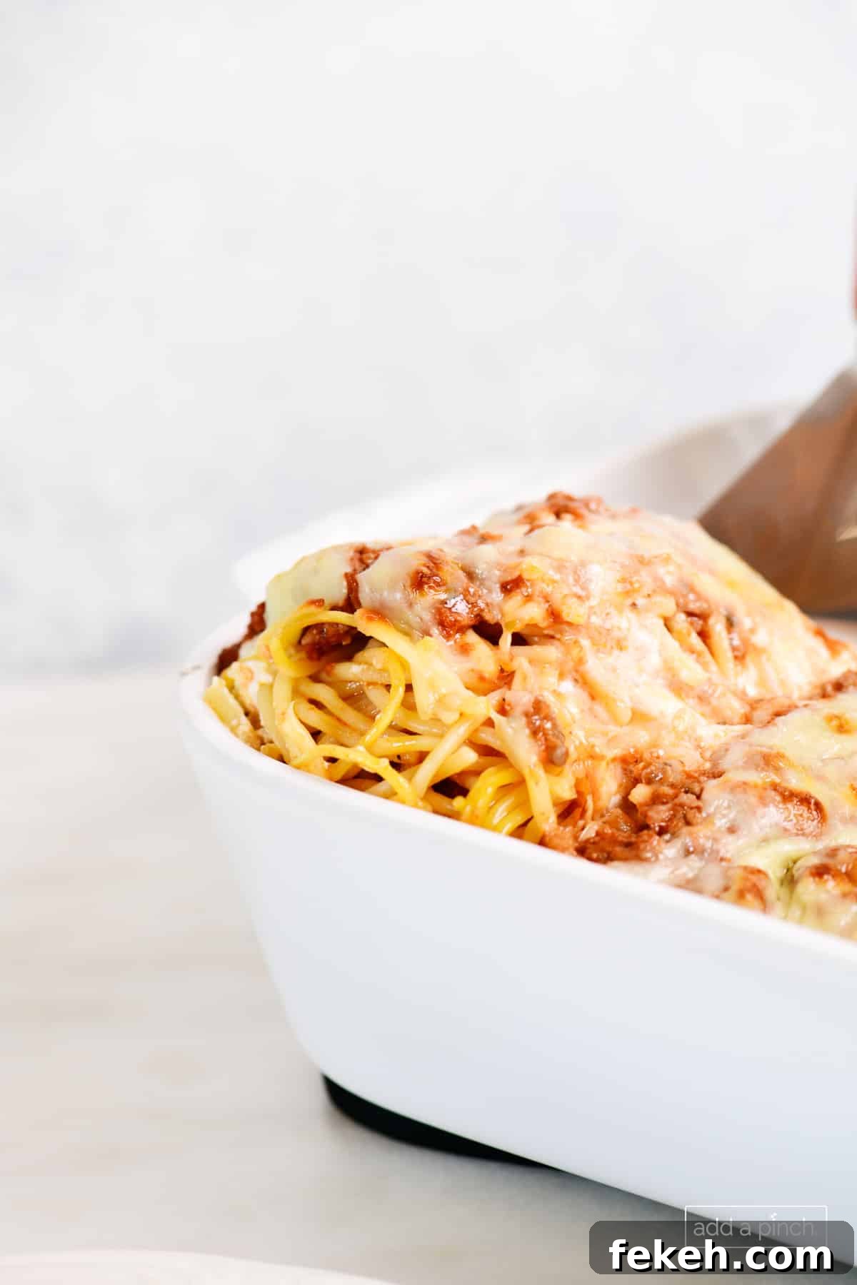 Cheesy Baked Spaghetti Casserole Recipe for Weeknight Dinners 13 Baked million dollar spaghetti in a baking dish.