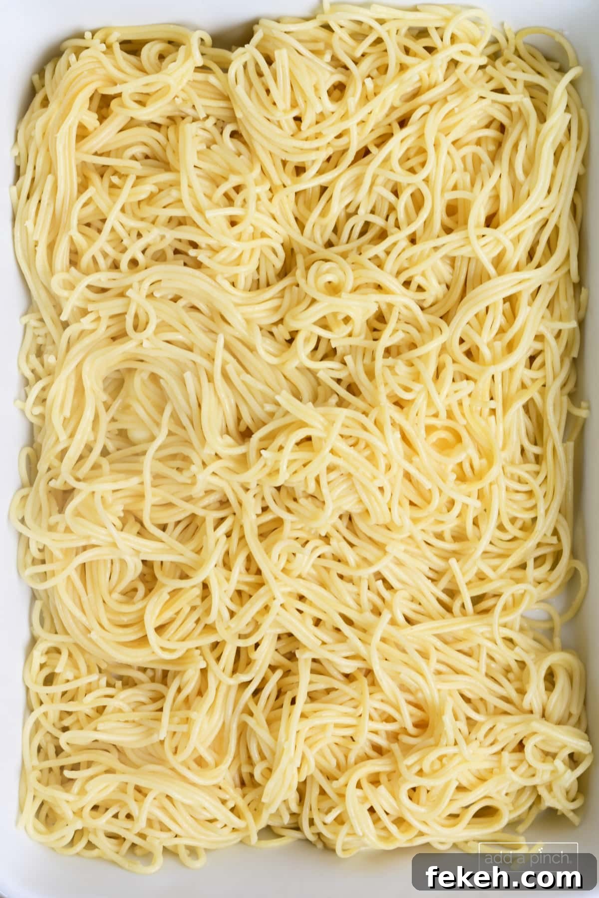 Cheesy Baked Spaghetti Casserole Recipe for Weeknight Dinners 7 Spaghetti in baking dish.