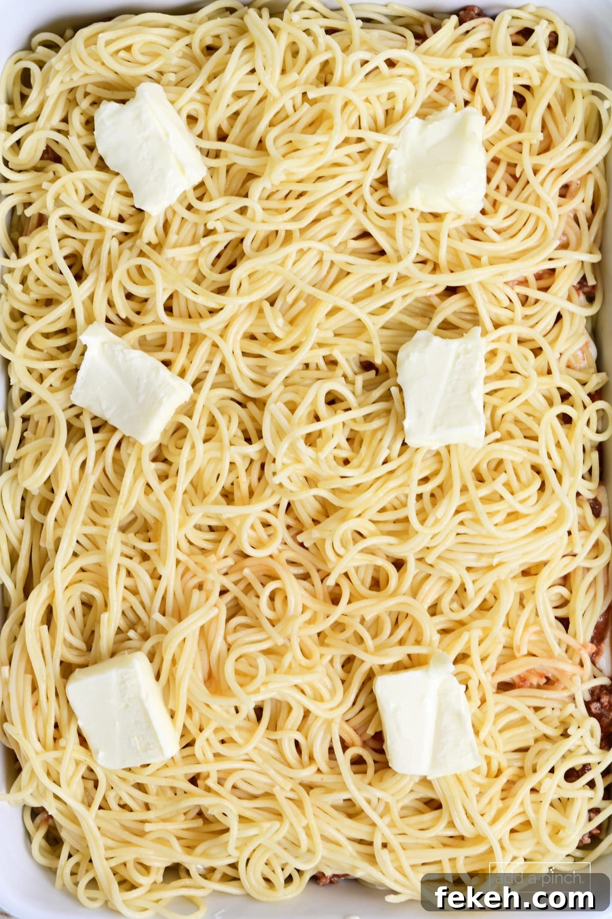 Cheesy Baked Spaghetti Casserole Recipe for Weeknight Dinners 10 Spaghetti and butter layers in baked spaghetti casserole.