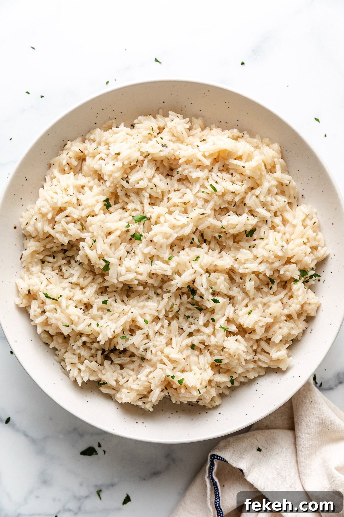 Speckled bowl filled with herb rice.
