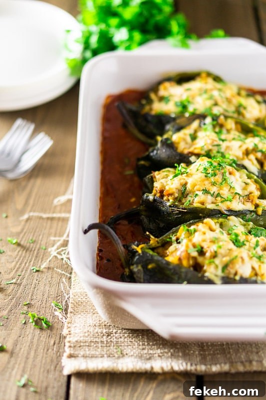 Baked Chorizo and Butternut Squash Chile Rellenos Recipe 8 A pan of baked chorizo-butternut squash chile rellenos with ranchero sauce.