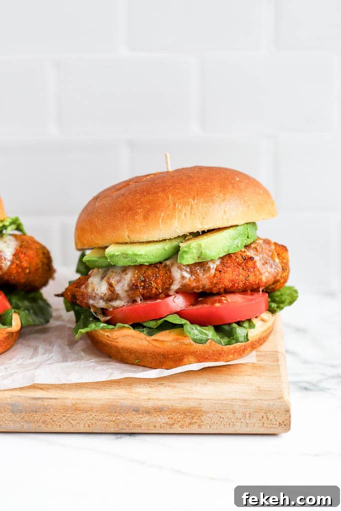 Crispy Air Fryer Chicken Burger Recipe for Juicy Patties 2 crispy air fryer chicken burger with melted cheese, lettuce, and tomato on toasted bun