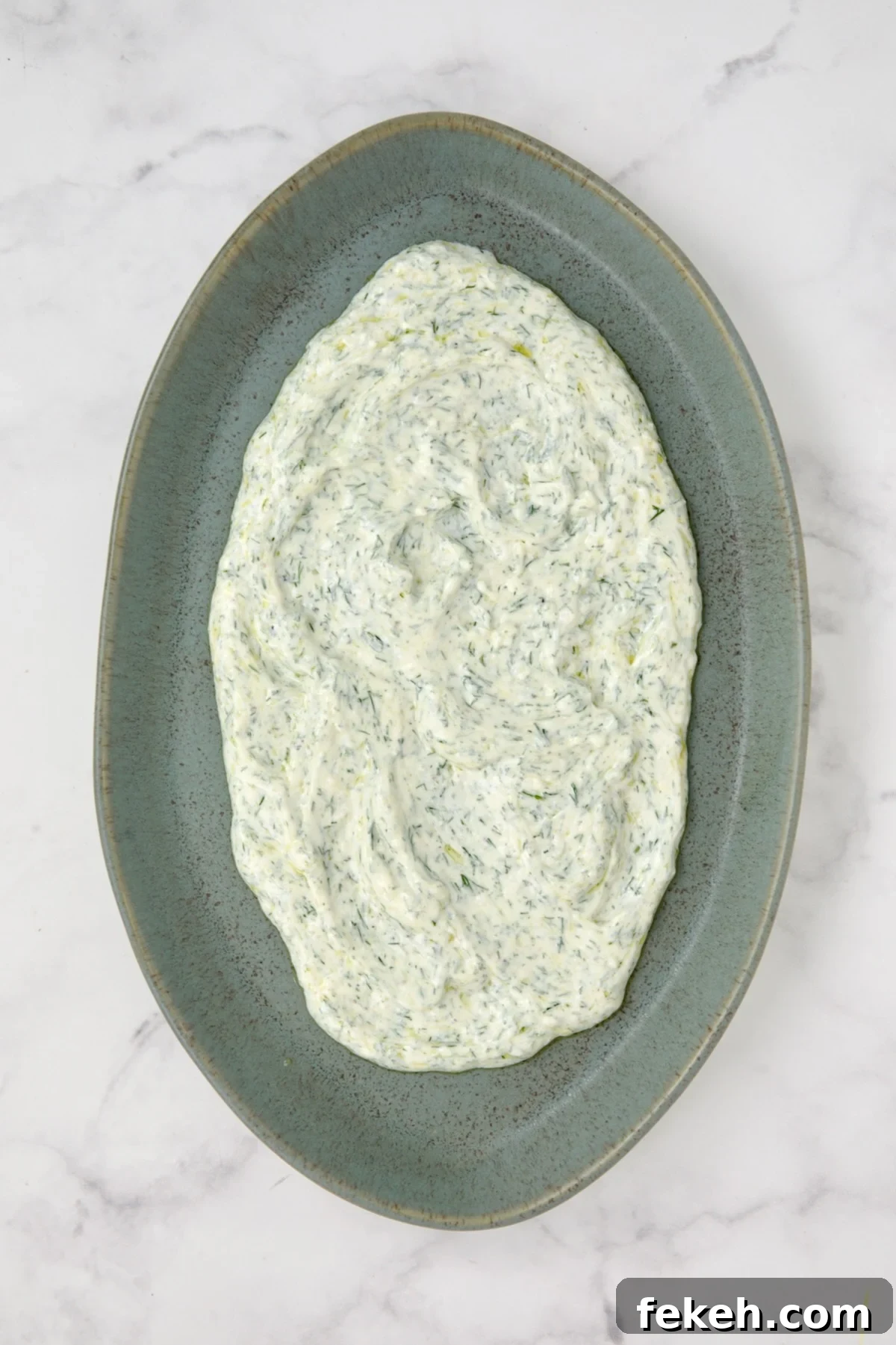Mediterranean Grilled Zucchini with Dill Yogurt & Feta 9 Dill yogurt spread out on blue platter.