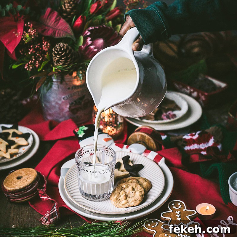 pouring milk for the traditional plate of cookies for Santa