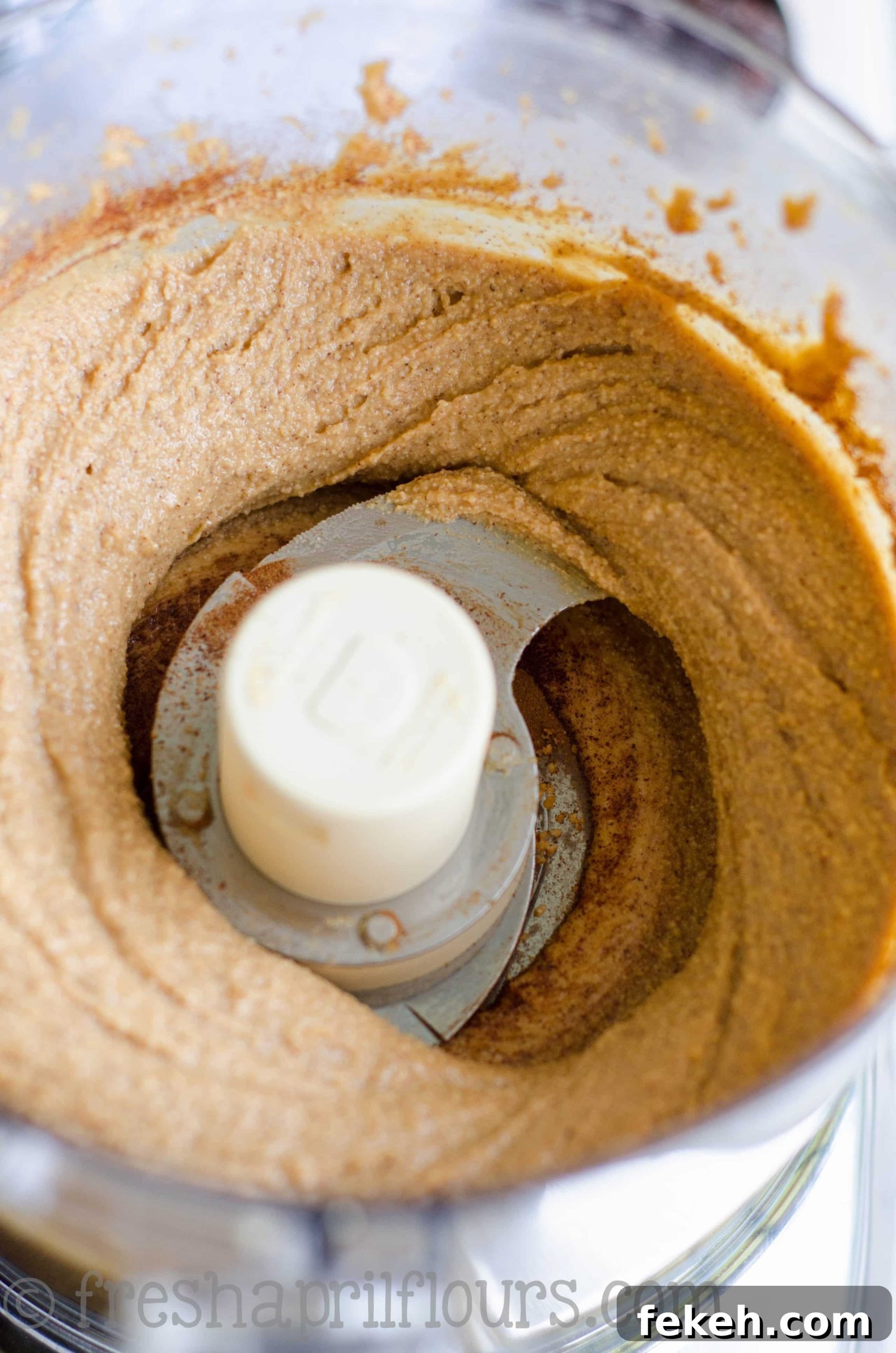 cinnamon raisin peanut butter in the bowl of a food processor