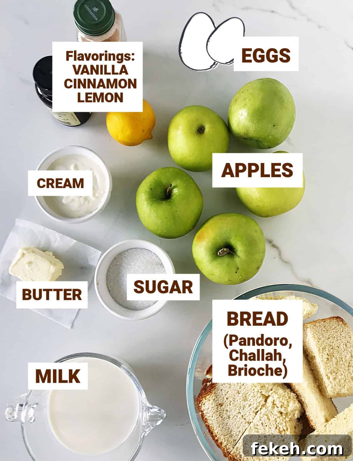Ingredients for apple bread pudding in bowls and on white surface, including eggs and small bottles.