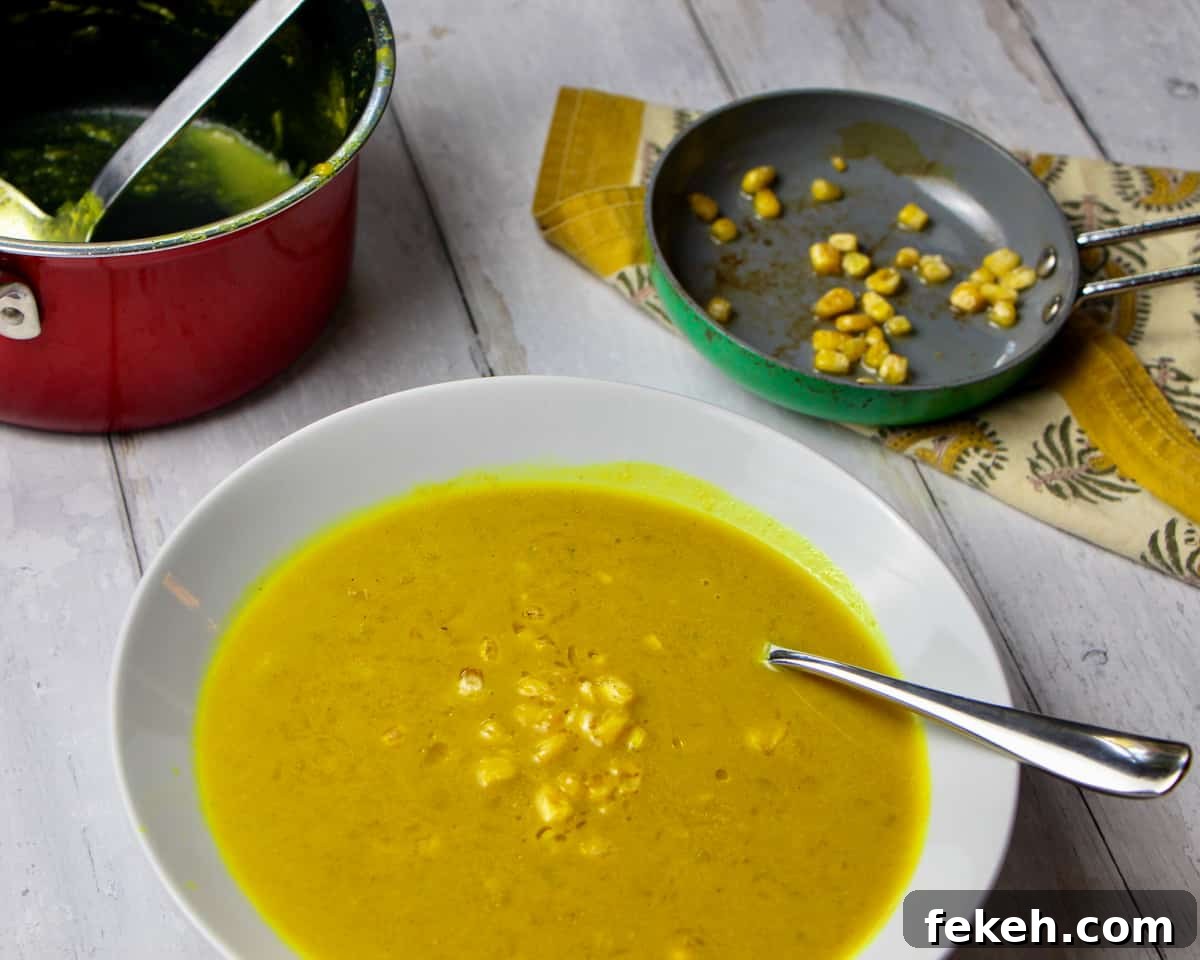 Bowl of pumpkin and sweetcorn soup with roasted sweetcorn bits on top