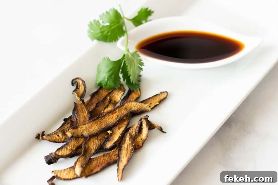 Mushroom Jerky on white plate with soy sauce on side