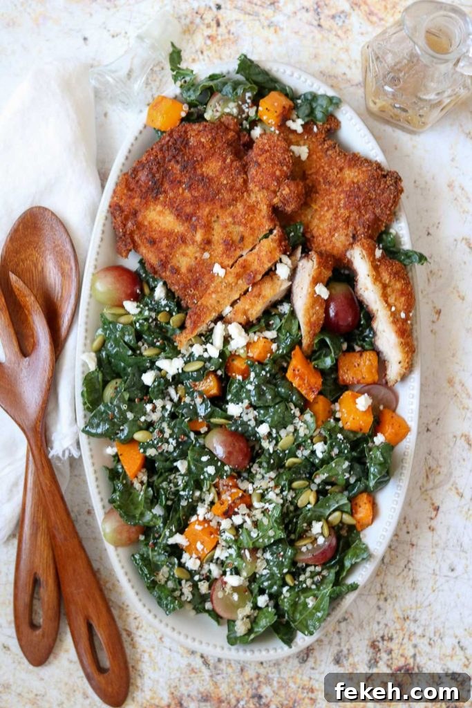 chicken schnitzel and kale autumn salad on platter with serving set 