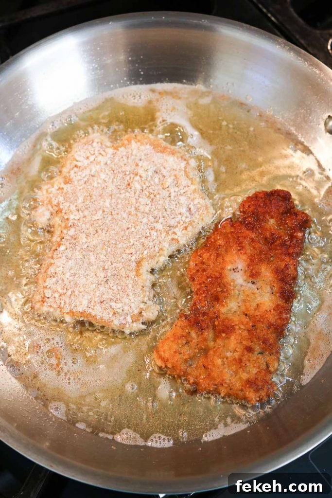 Chicken Schnitzel frying in pan 