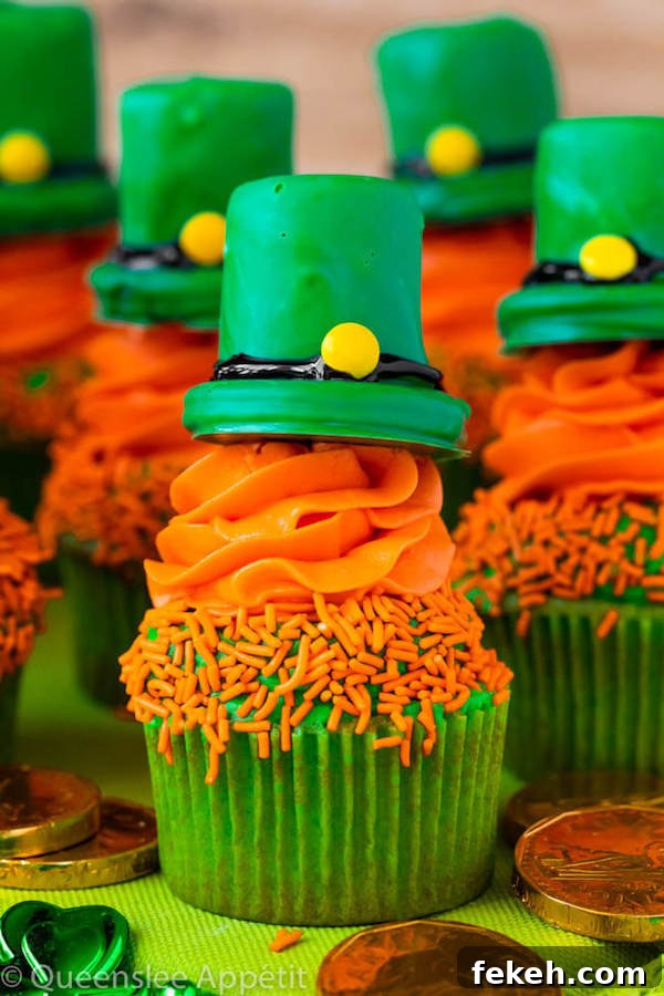These Leprechaun Hat Cupcakes are super adorable and fun to make! A moist green vanilla cupcake stuffed with gold sprinkles, topped with a fluffy green and orange vanilla frosting and a cute little leprechaun hat sitting on top! This is the ultimate St. Patrick’s Day treat!