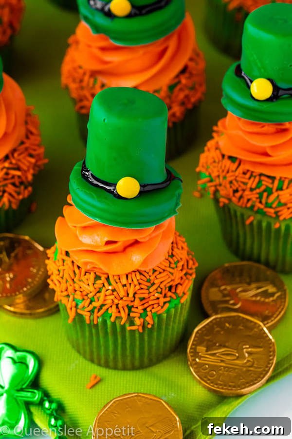 These Leprechaun Hat Cupcakes are super adorable and fun to make! A moist green vanilla cupcake stuffed with gold sprinkles, topped with a fluffy green and orange vanilla frosting and a cute little leprechaun hat sitting on top! This is the ultimate St. Patrick’s Day treat!