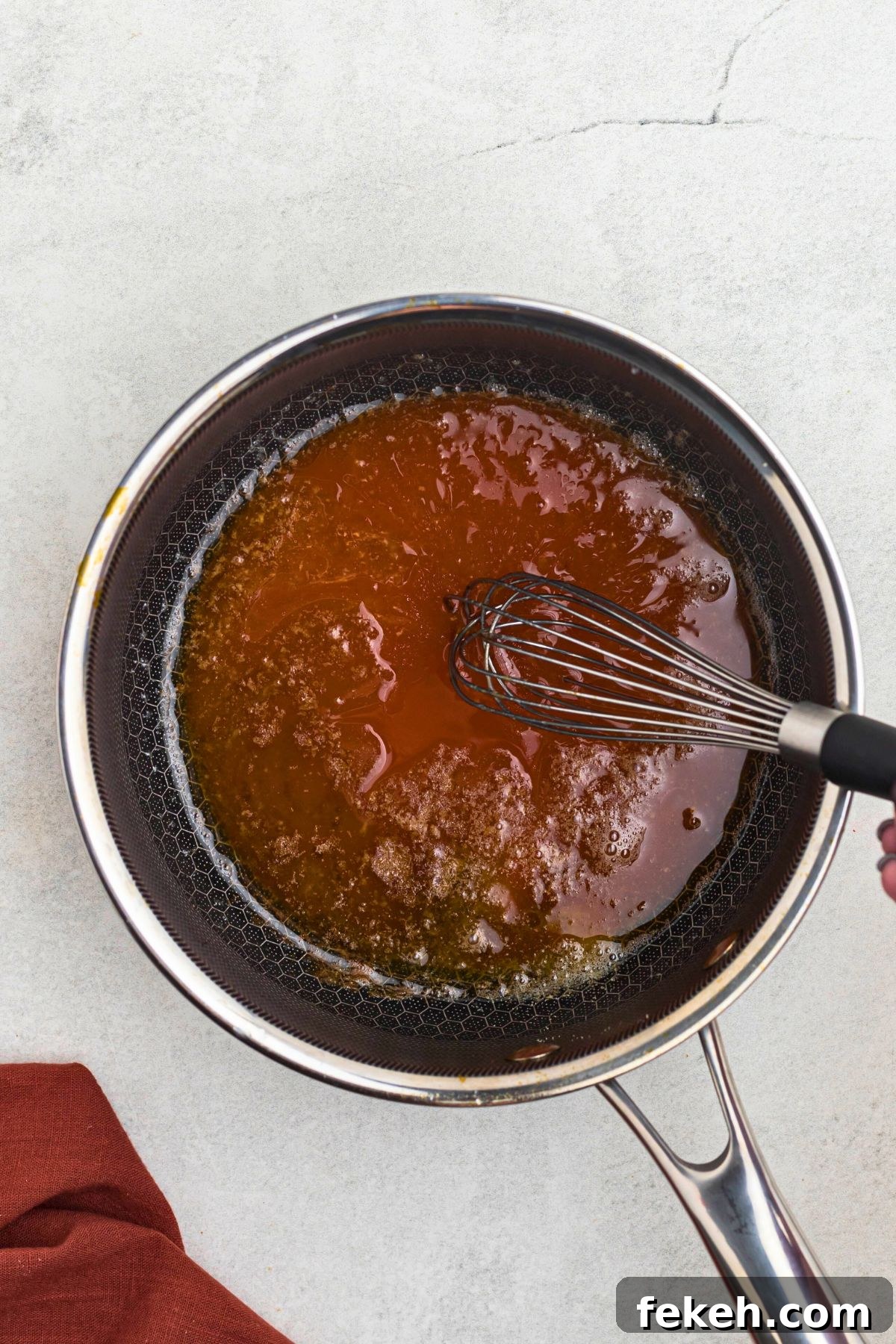 Sauce in a pan with melted butter and other ingredients. 