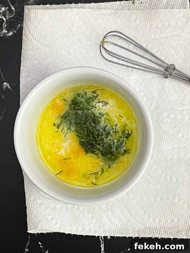 Garlic dill butter in a white ramekin.