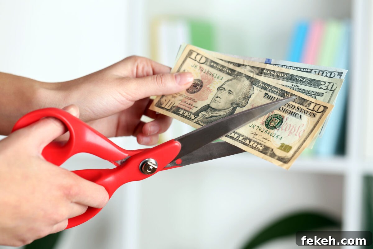 scissors cutting money